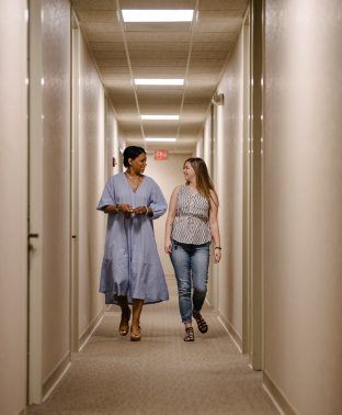 two arkana team members walking down hall and talking Careers at Arkana Laboratories