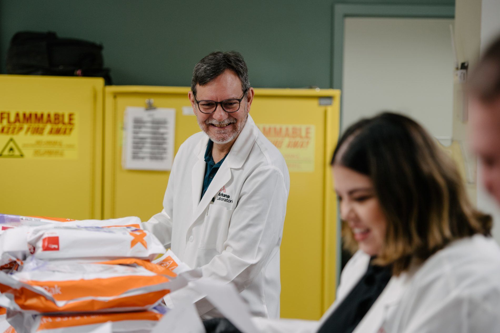 Lab team members unpacking cases as they arrive from fedex