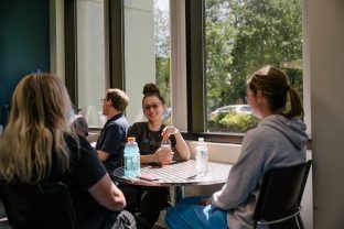 lab team members joined around a table for lunch at Arkana Labs