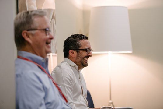 physicians laughing in case conference at Arkana Laboratories