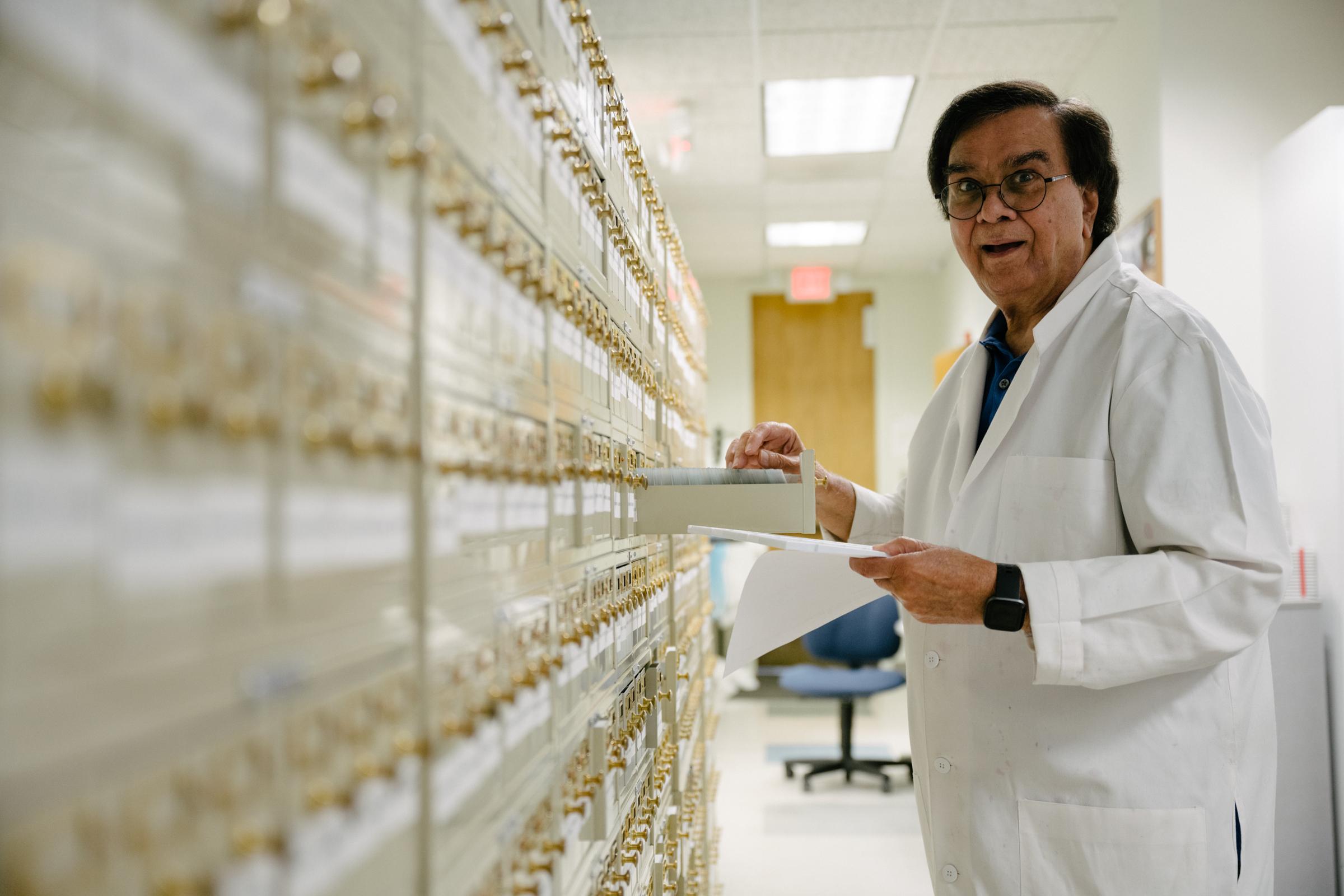 lab team member making funny face while filing slides