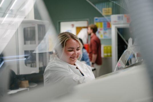 lab team member processing slides and placing slides in stainers - Contact Arkana Labs