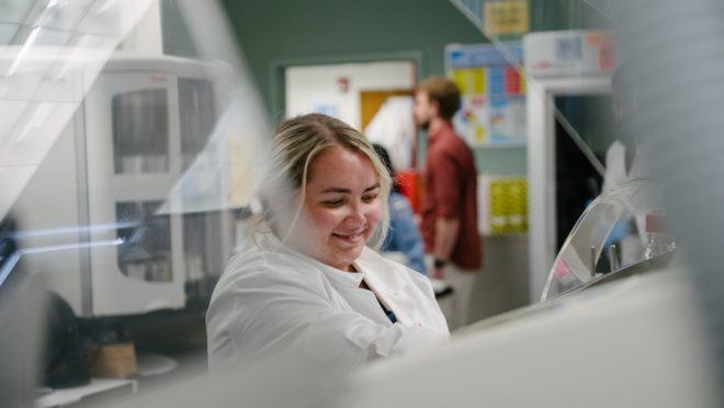 lab team member processing slides and placing slides in stainers - Contact Arkana Labs