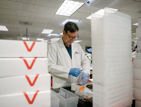 lab staff member processing kits - Contact Arkana Labs