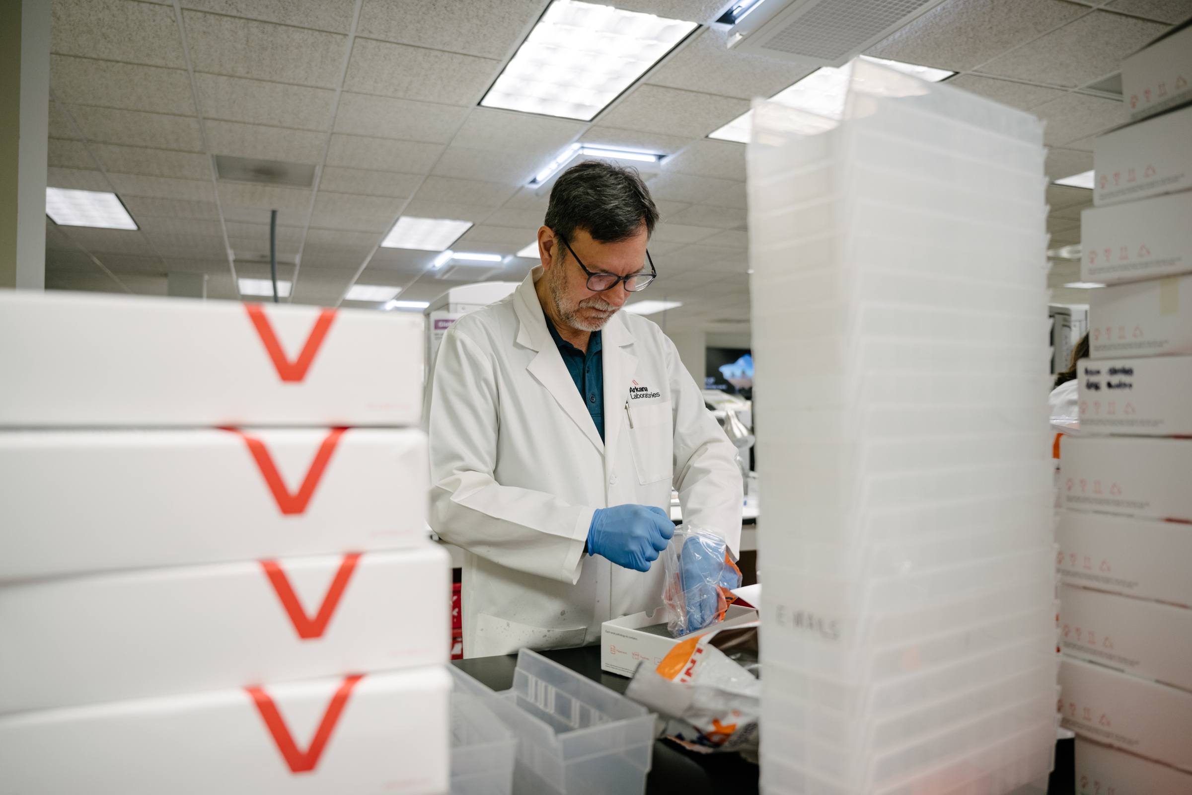 lab staff member processing kits - Contact Arkana Labs