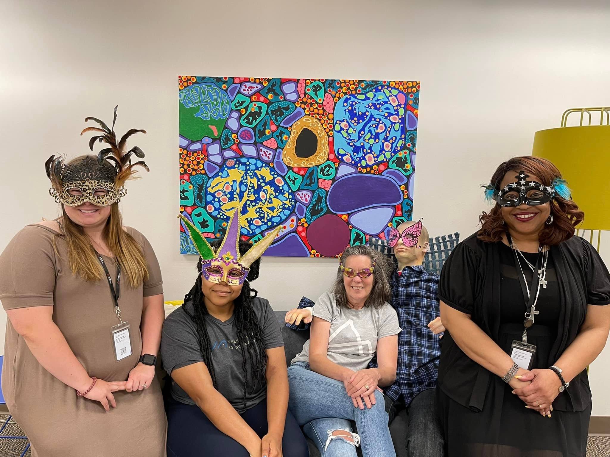 transcription team wearing masquerade masks