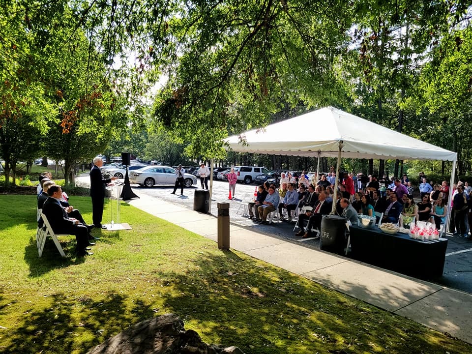 crowd of people gathered outside arkana laboratories for arkansas economic development event