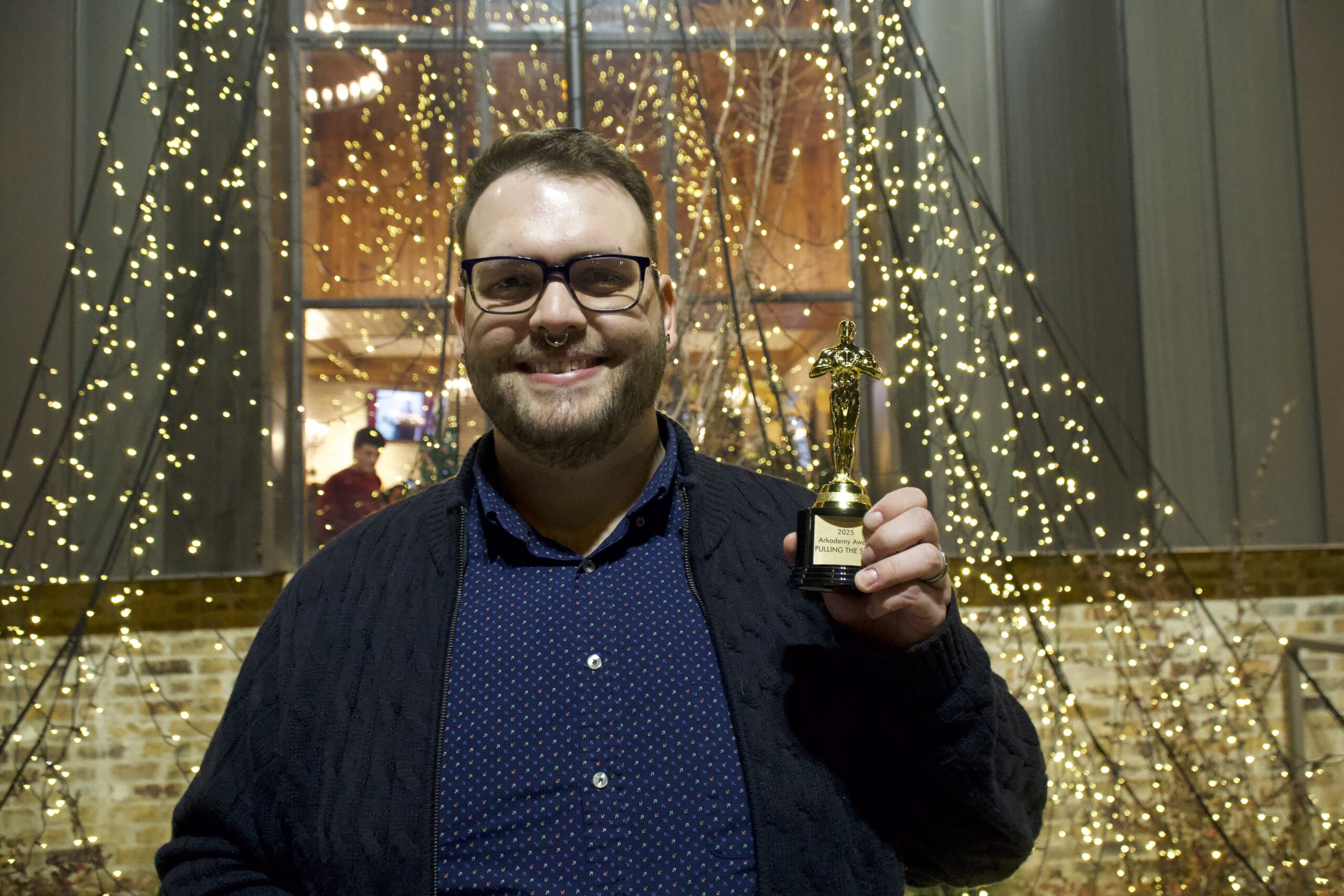 Arkana's pull the sled winner pictured holding up a trophy