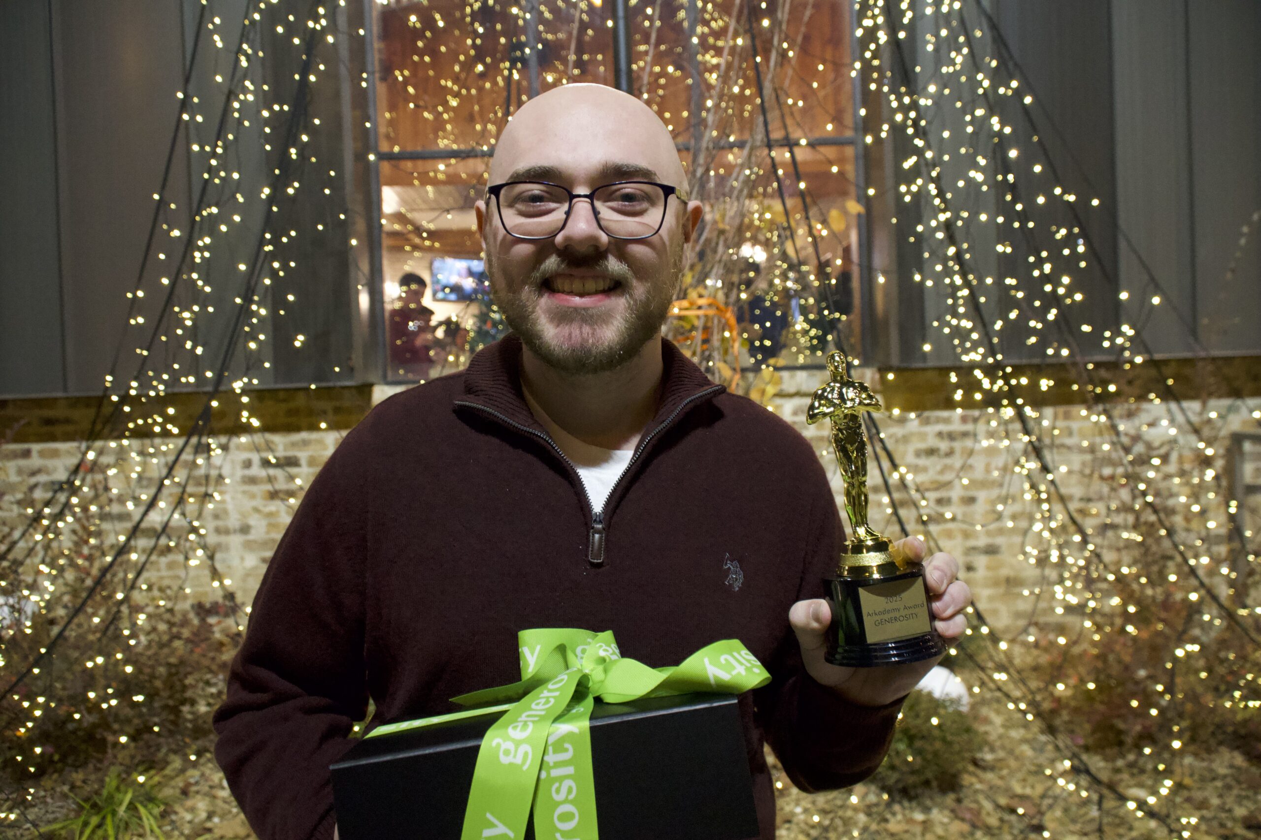 Arkana generosity winner posing with award and wrapped gift